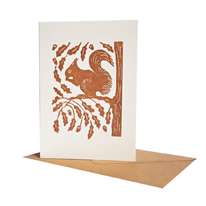 A Red Squirrel perched on tree branch printed with rust red ink. Suitable as a greeting or notecard.