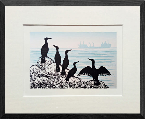 Framed lino print in black and blue grey ink of cormorants on rocks as cargo ship sails by in the distance