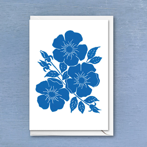 Linocut greeting card of dog rose flowers printed with bright indigo colour ink with envelope