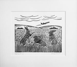 Mounted linocut in black ink of hares playing at airstrip
