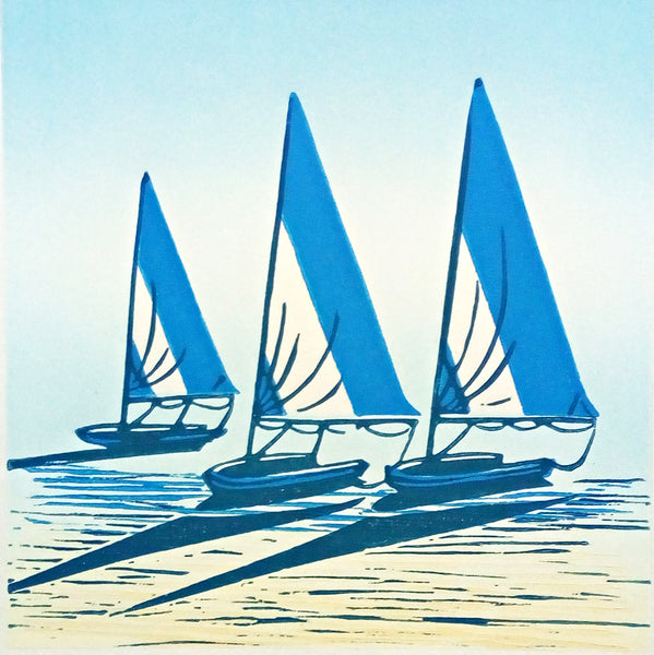 Linocut in blue, black and yellow ink of sailing boats on the shore