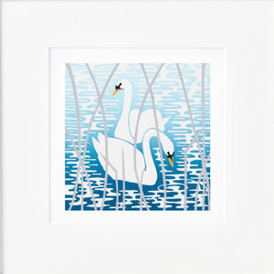 Mounted linocut of two white swans that glide upon water printed with blue ink tones